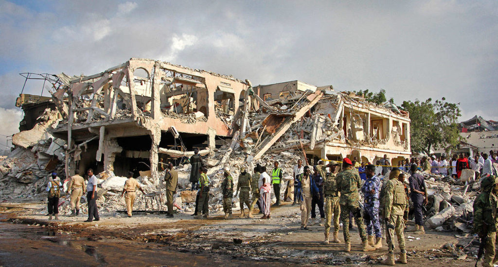 Somali security forces and others gather and search for bodies near destroyed buildings at the scene of Saturday’s blast in Mogadishu, Somalia. (AP Photo/Farah Abdi Warsameh)
