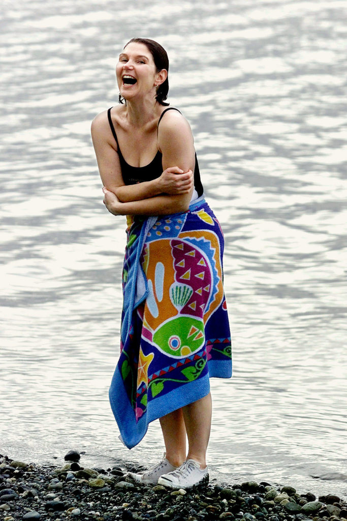 New polar bear club member Herald columnist Julie Muhlstein shivers after taking a Dec. 27, 2001, plunge into Port Susan at Kayak County Park. (Photo by Elizabeth Armstrong)
