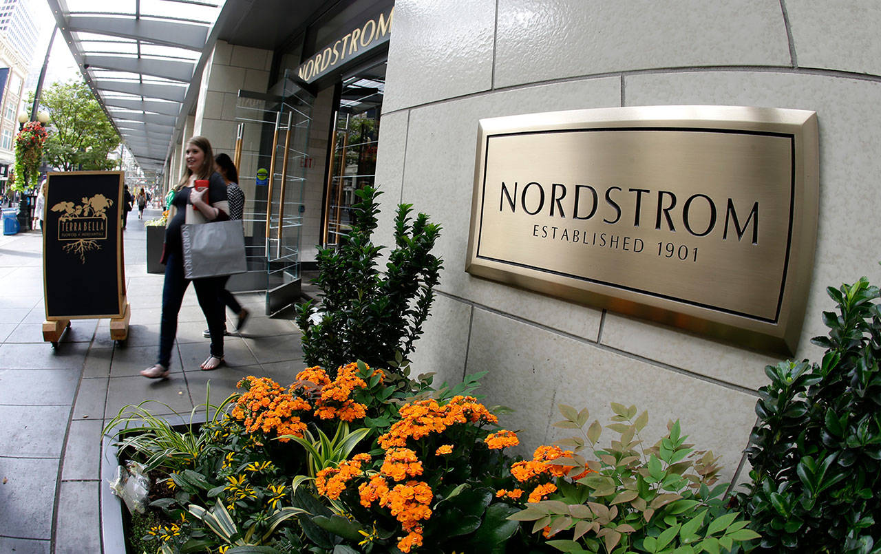 Shoppers come and go from Nordstrom’s flagship store in downtown Seattle. (AP Photo/Ted S. Warren)