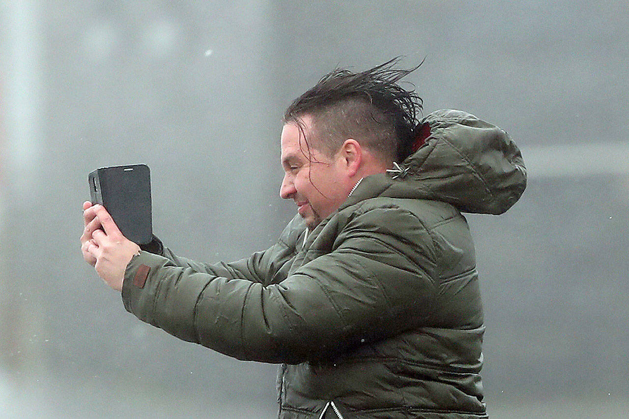A man take selfie in the high wind at Lahinch on the west coast of Ireland on Monday as the remnants of Hurricane Ophelia begin to hit Ireland and parts of Britain.