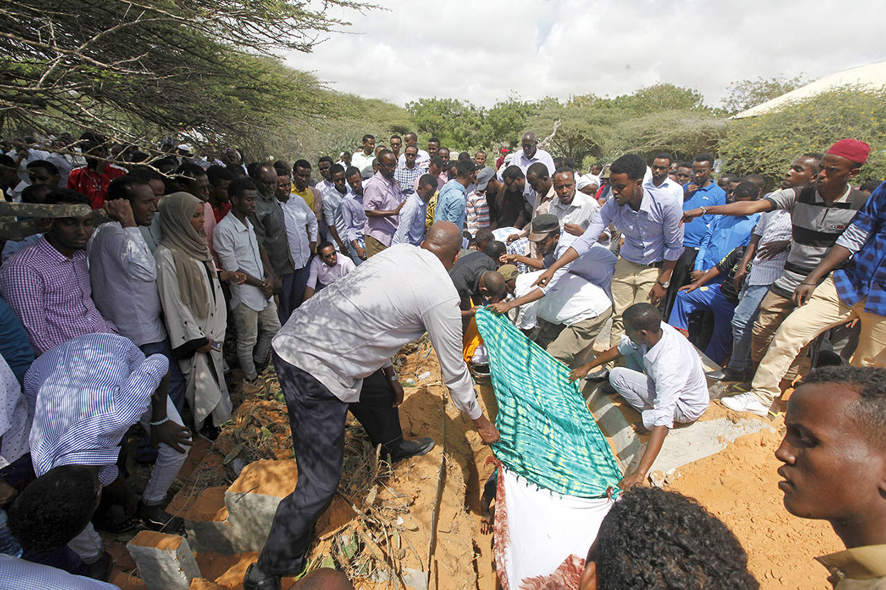 Somalis bury a body of a victim who died in Saturday’s truck blast, in Mogadishu’s Medina hospital graveyard in Mogadishu, Somalia, on Tuesday. (AP Photo/Farah Abdi Warsameh)