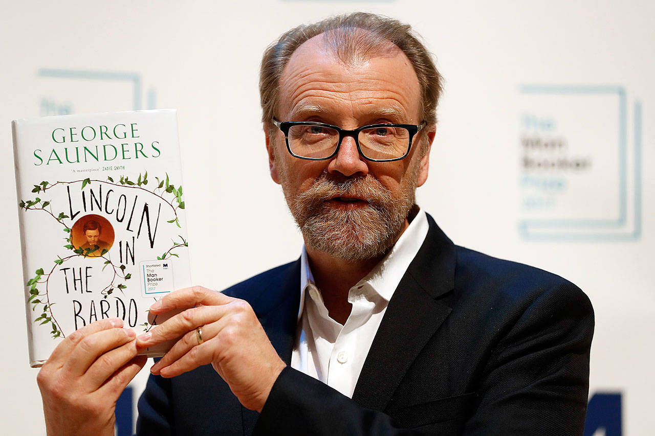 American author George Saunders with his book, “Lincoln in the Bardo,” in London on Monday. (AP Photo/Kirsty Wigglesworth)