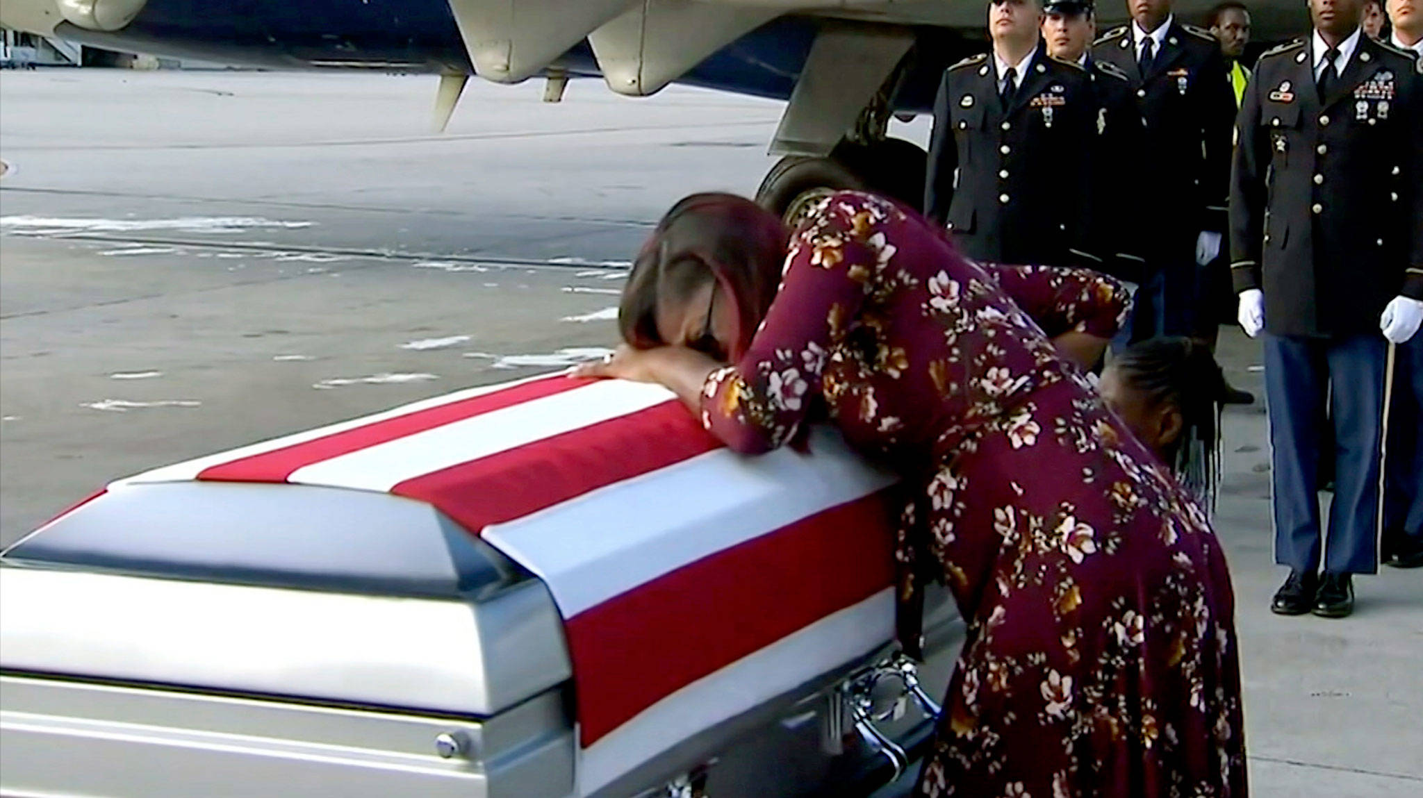 Myeshia Johnson cries over the casket of her husband, Sgt. La David Johnson, who was killed in an ambush in Niger, upon his body’s arrival in Miami on Tuesday. (WPLG via AP)