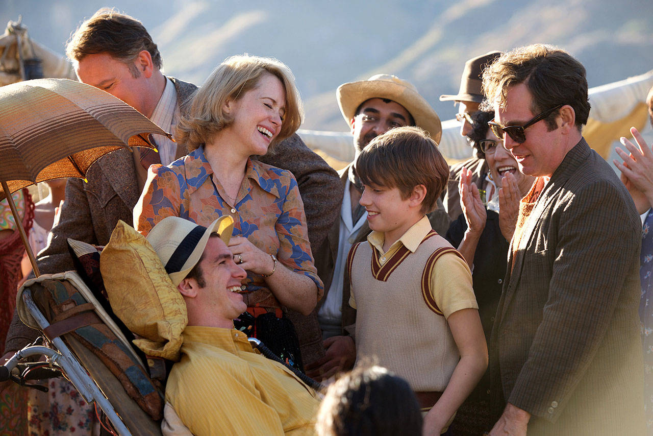 In “Breathe,” Andrew Garfield, foreground, portrays the late disability advocate Robin Cavendish with, from left, actors Hugh Bonneville, Claire Foy, Harry Marcus and Tom Hollander. (Bleecker Street-Participant Media)
