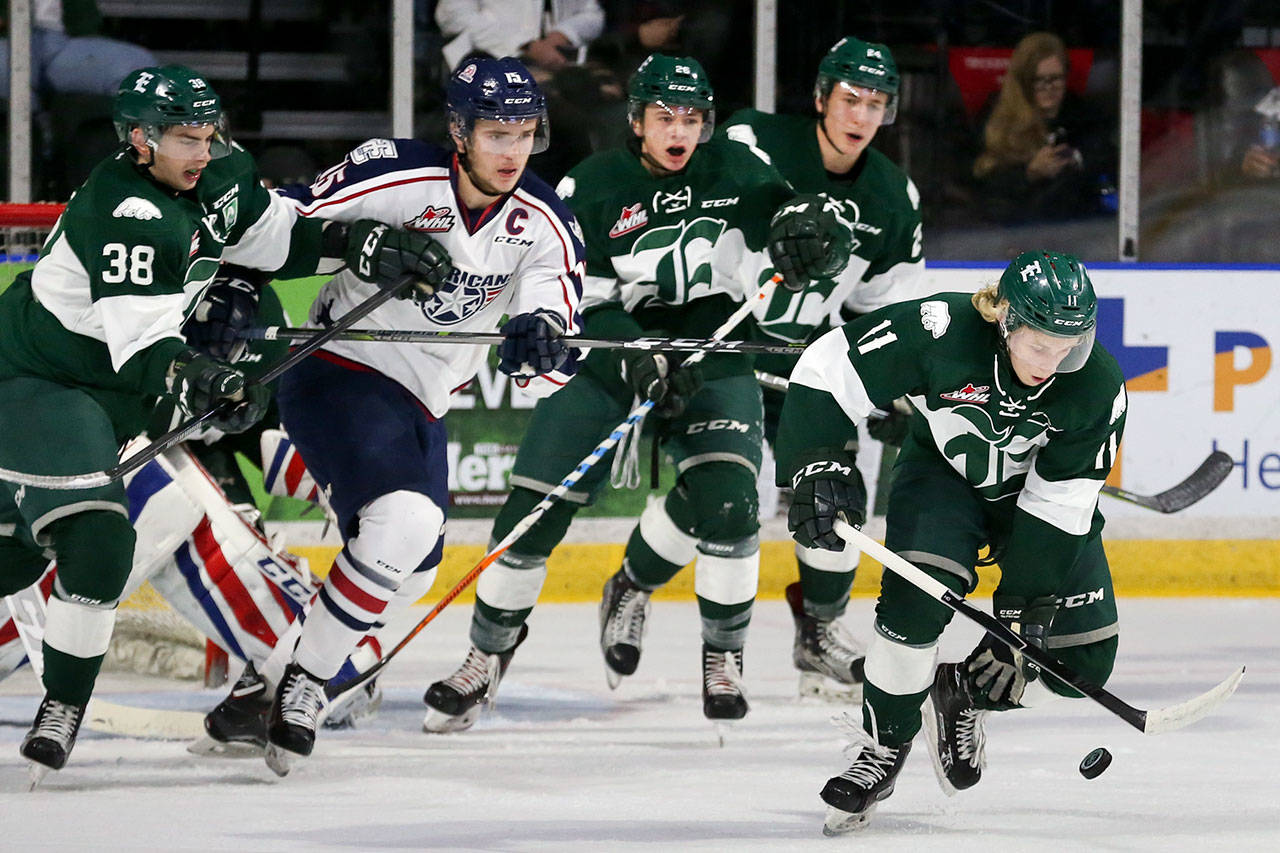 The Silvertips’ Orrin Centazzo (far right) gathers a loose puck during a game against the Americans on Oct. 18, 2017, at Xfinity Arena in Everett. (Kevin Clark / The Herald)