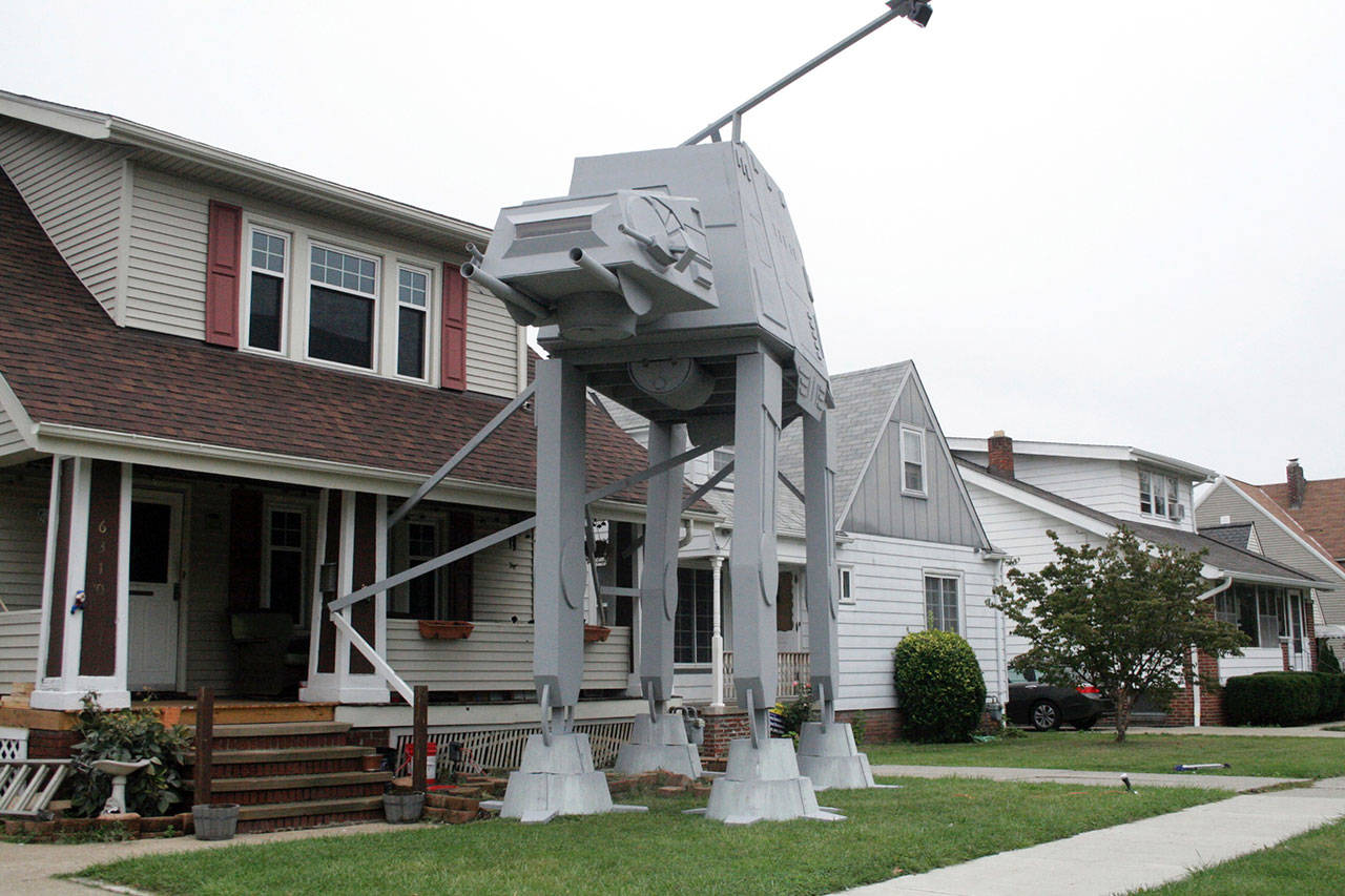 A replica four-legged All Terrain Armored Transport, or AT-AT walker, is a hit in Parma, Ohio. Owner Nick Meyer tells Cleveland.com he used wood, hard foam and plastic barrels. He says he enjoys the “Star Wars” movies but isn’t a fanatic and simply thought the display would be unique. (Patrick Cooley / The Plain Dealer-Cleveland.com)