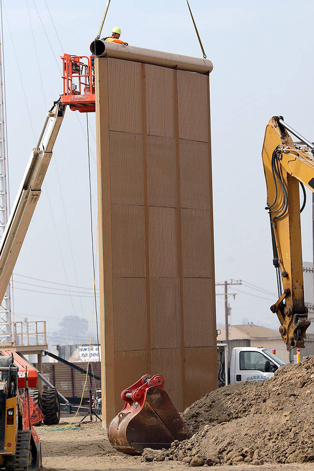A border wall prototype stands near the border with Tijuana, Mexico, on Thursday in San Diego. (AP Photo/Gregory Bull)