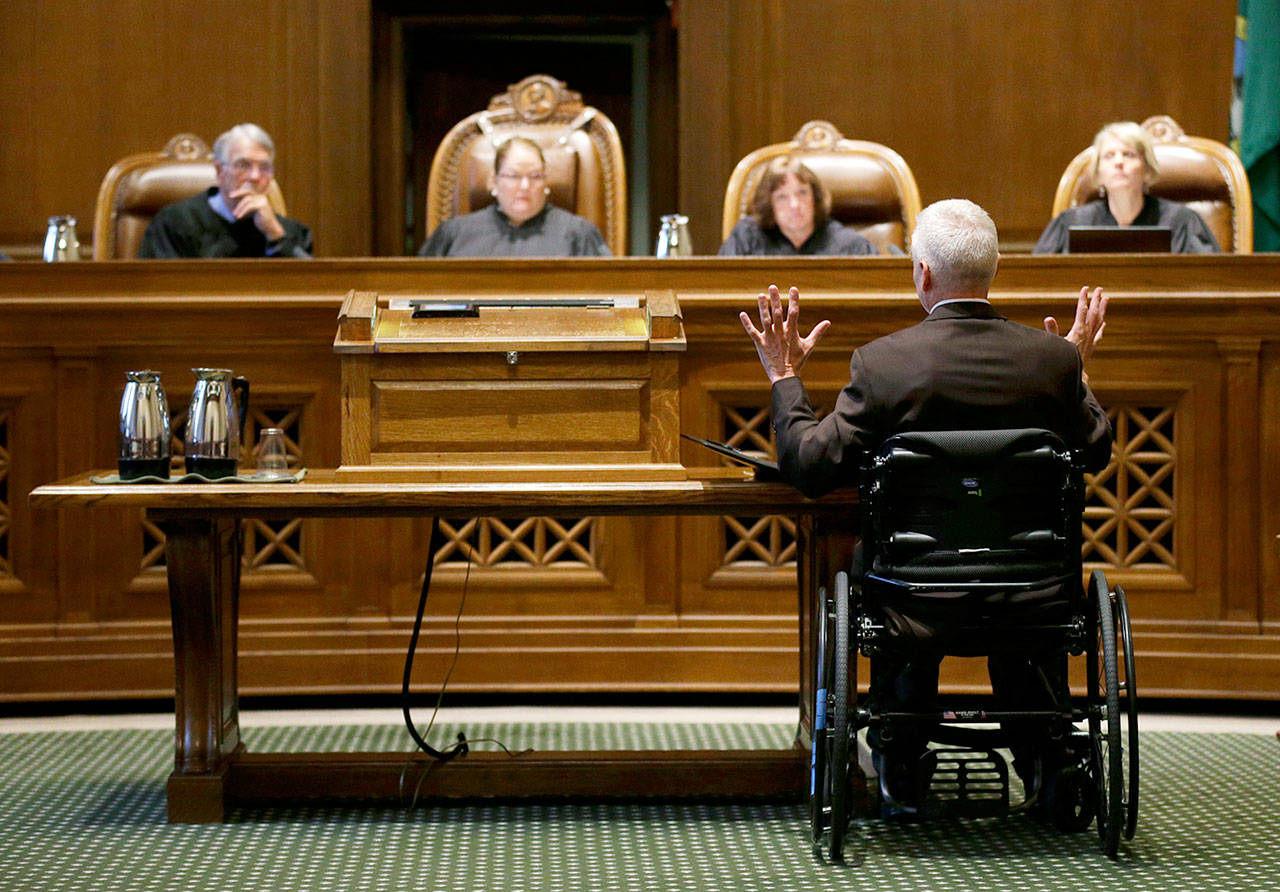 Tom Ahearne (lower right), the lead attorney in a lawsuit against the state of Washington regarding the funding of education, speaks Tuesday during a Washington Supreme Court hearing in Olympia. The hearing was held to determine if Washington state has complied with a court mandate to fully fund the state’s basic education system. (AP Photo/Ted S. Warren)
