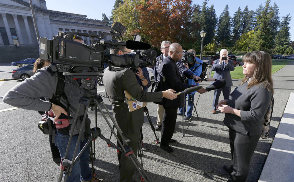 Stephanie McCleary (right), one of the plaintiffs in a lawsuit against the state of Washington regarding the funding of education, talks to reporters Tuesday, after she attended arguments in a Washington Supreme Court hearing in Olympia to determine whether the state has fulfilled its constitutional duty to fully fund basic education. (AP Photo/Ted S. Warren)
