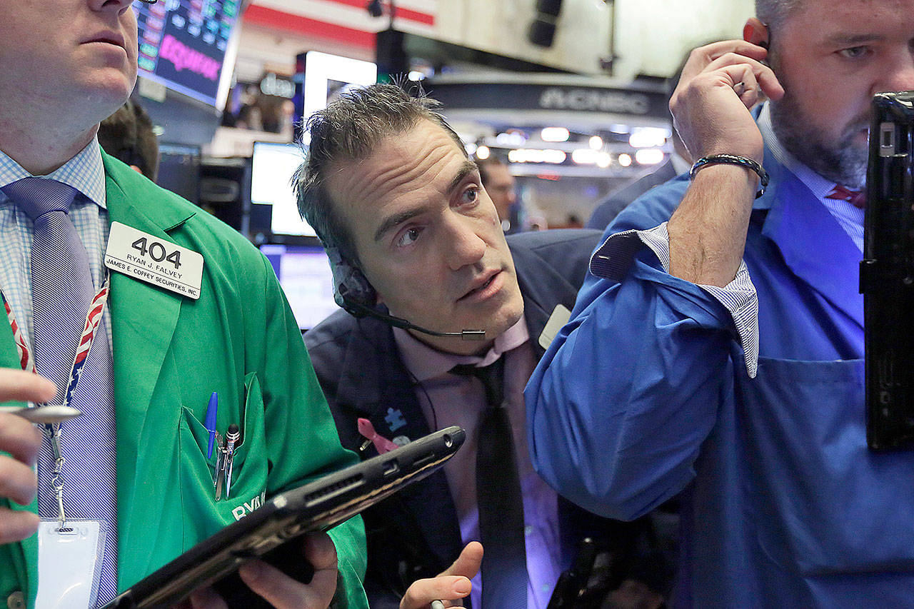 A trader squeezes between others on the floor of the New York Stock Exchange on Thursday. (AP Photo/Richard Drew)