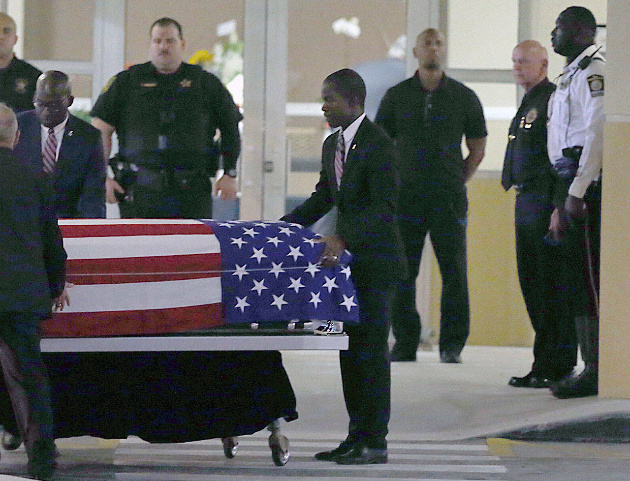 The casket of Sgt. La David T. Johnson of Miami Gardens, who was killed in an ambush in Niger, is wheeled out after a viewing at the Christ The Rock Church, Friday, Oct. 20, 2017 in Cooper City, Fla. (Pedro Portal/Miami Herald via AP)