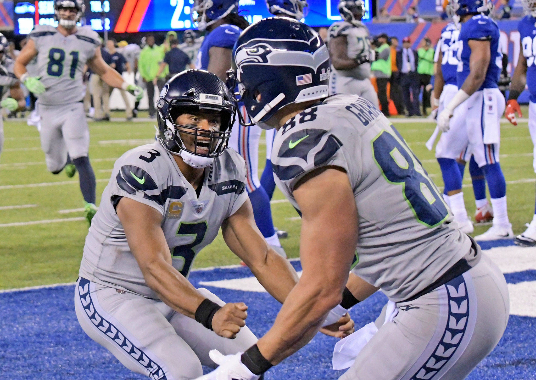Seahawks quarterback Russell Wilson (left) celebrates with Jimmy Graham after Graham caught a touchdown pass during the second half of a game against the Giant on Oct. 22, 2017, in East Rutherford, N.J. (AP Photo/Bill Kostroun)