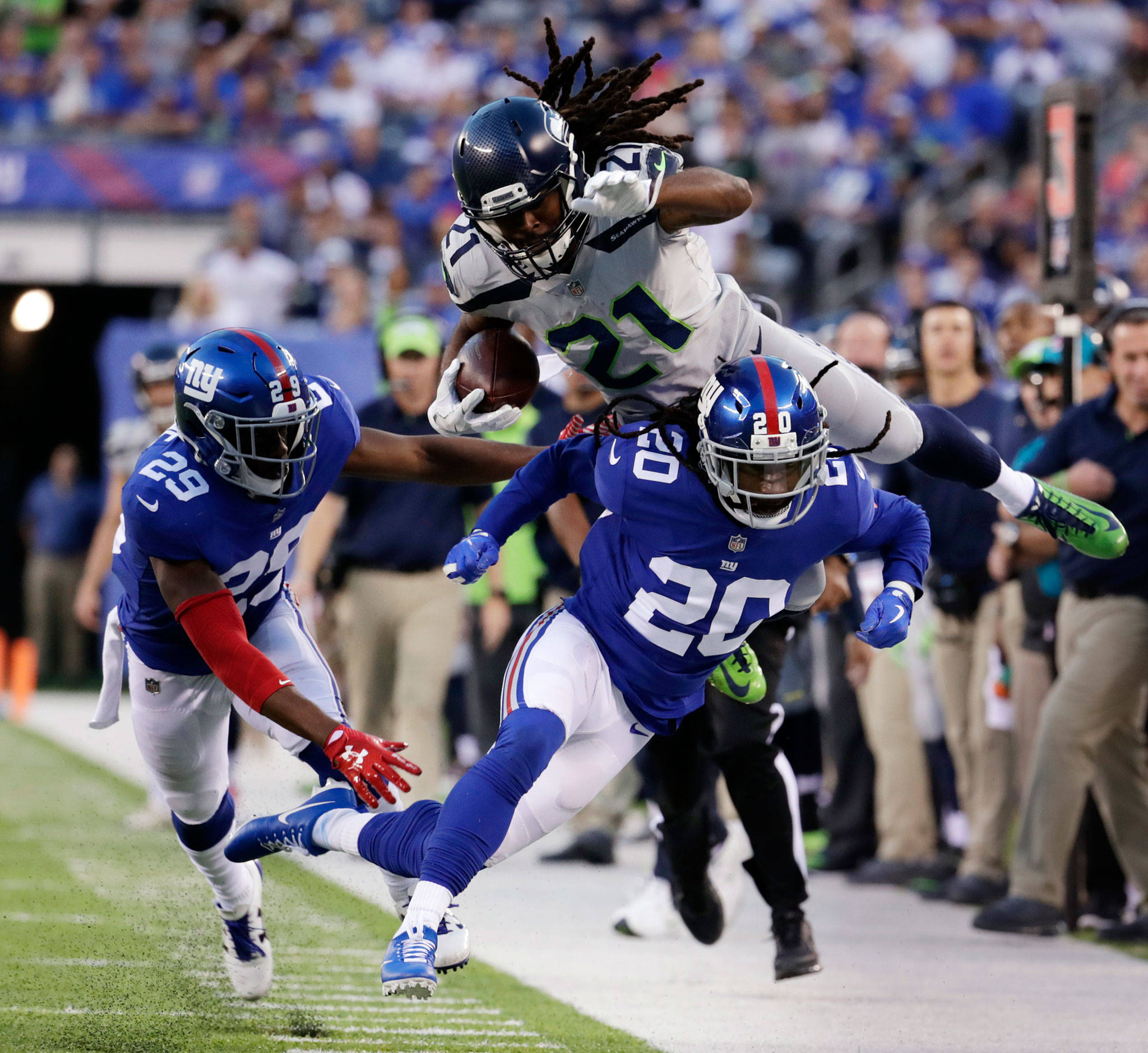 The Seahawks’ J.D. McKissic jumps over the Giants’ Janoris Jenkins (20) during the first half of a game Oct. 22, 2017, in East Rutherford, N.J. (AP Photo/Julio Cortez)