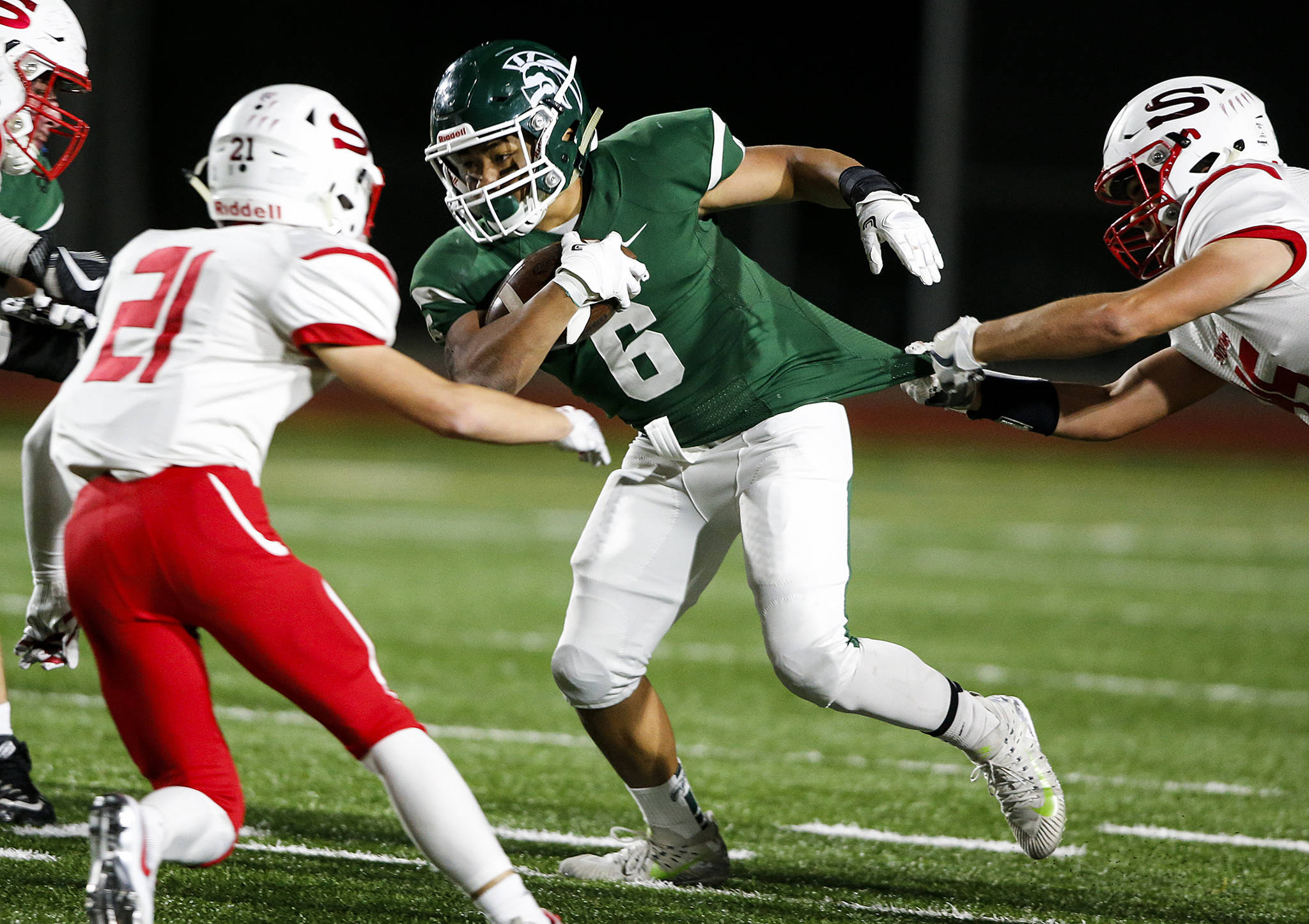 Edmonds-Woodway’s Cappasio Cherry (6) breaks a tackle during a game against Snohomish at Edmonds Stadium on Friday, Oct. 27. (Ian Terry / The Herald)