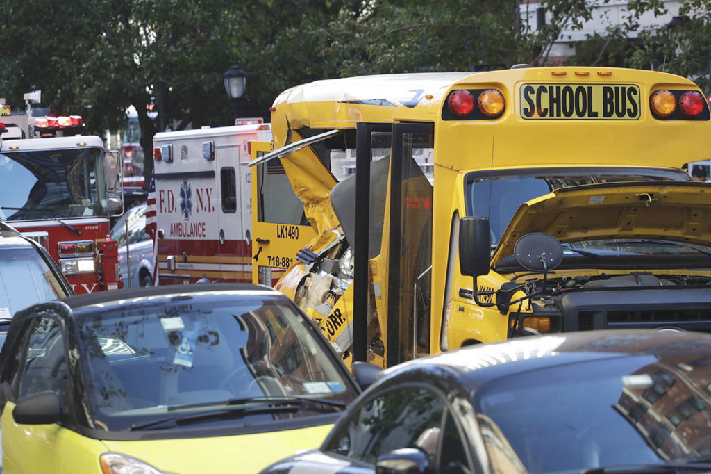 Authorities respond near a damaged school bus Tuesday in New York. (AP Photo/Mark Lennihan)
