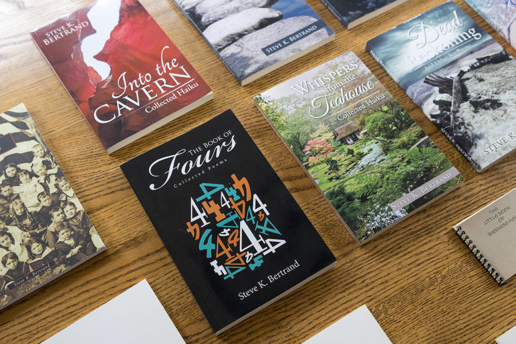 A selection of Steve K. Bertrand’s haiku books are seen at his home in Mukilteo. (Ian Terry / The Herald)

