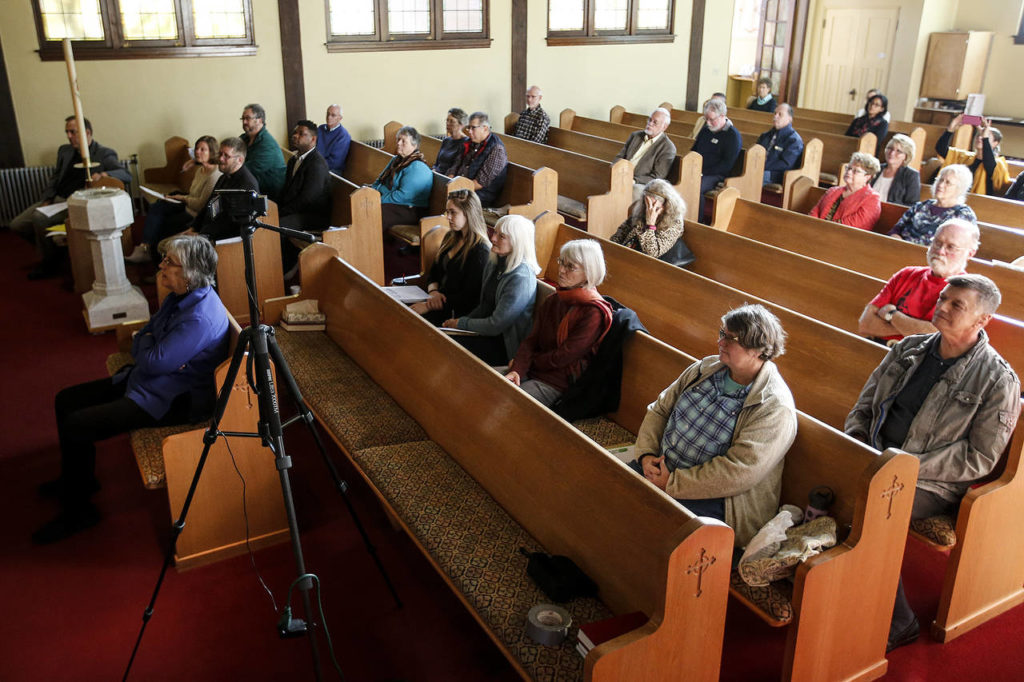 People listen to speakers Terry Kyllo and Aneelah Afzali at Trinity Lutheran Church in Everett on Oct. 24. (Ian Terry / The Herald)
