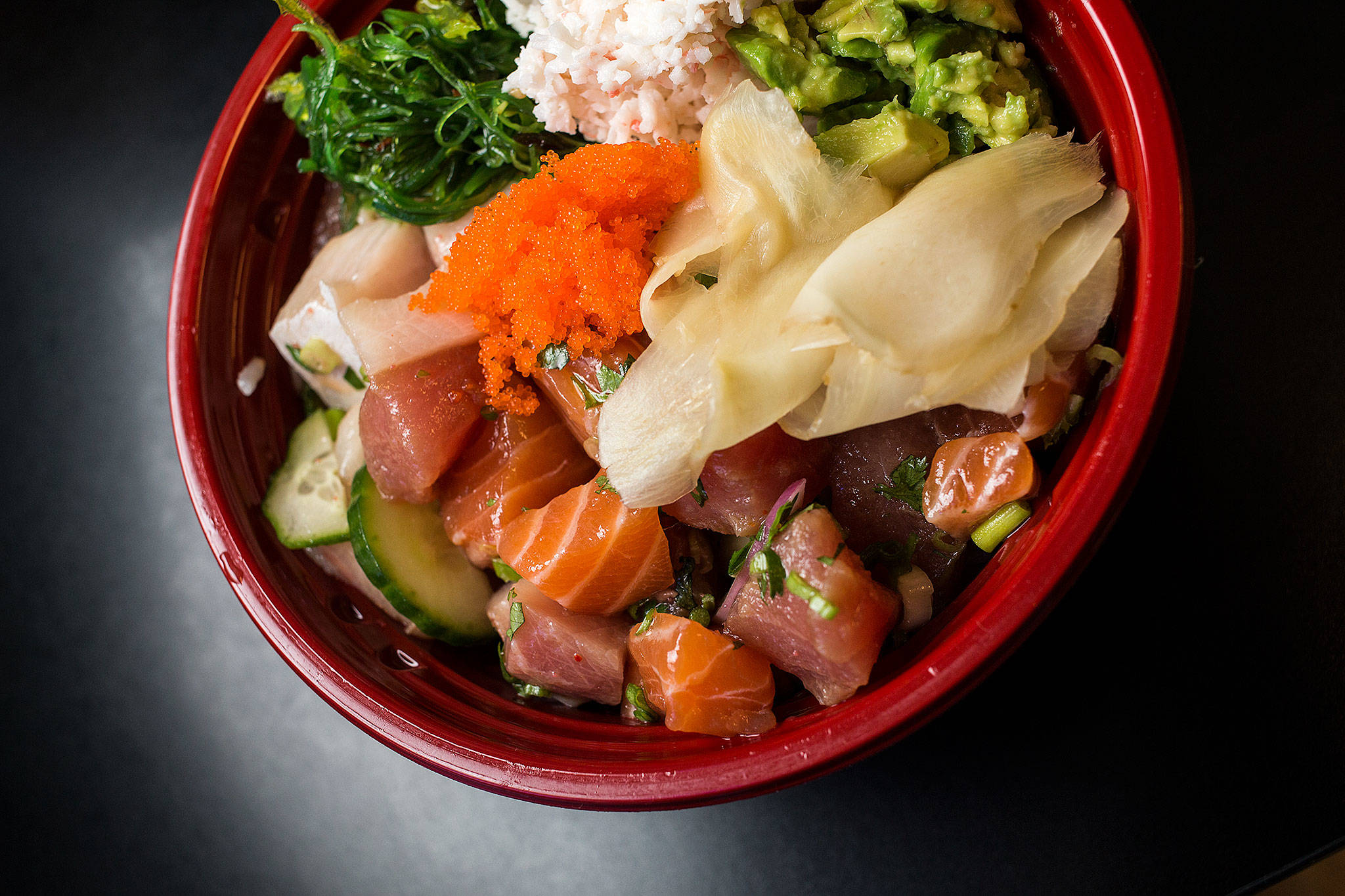 The geisha bowl poke of ahi tuna, yellow tail and salmon with rice, seaweed, edamame, cucumber, cilantro and imitation crab meat. (Andrew Bronson / The Herald)