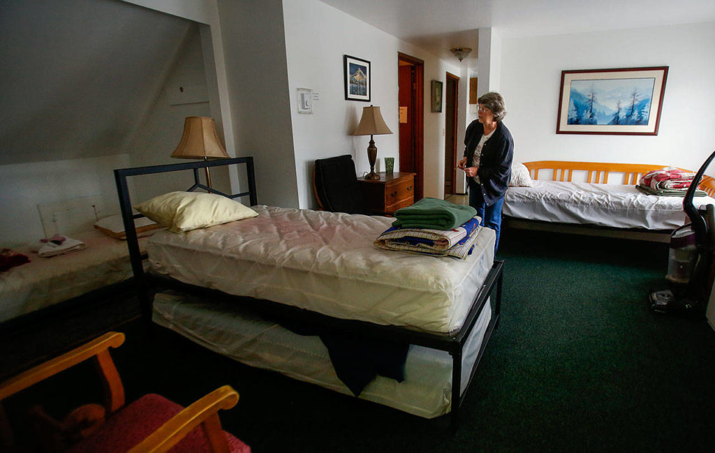 Volunteer Karol Bentley checks out one of three apartments at Matthew House. This one, with more than one bedroom, might handle a visiting family with kids. (Dan Bates / The Herald)
