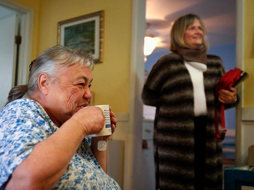 Shirley Lidel, 68 (left), and Joyce Dudder, a retiree from the Department of Corrections, enjoy some office banter with Matthew House Executive Director Linda Paz in early November. (Dan Bates / The Herald)
