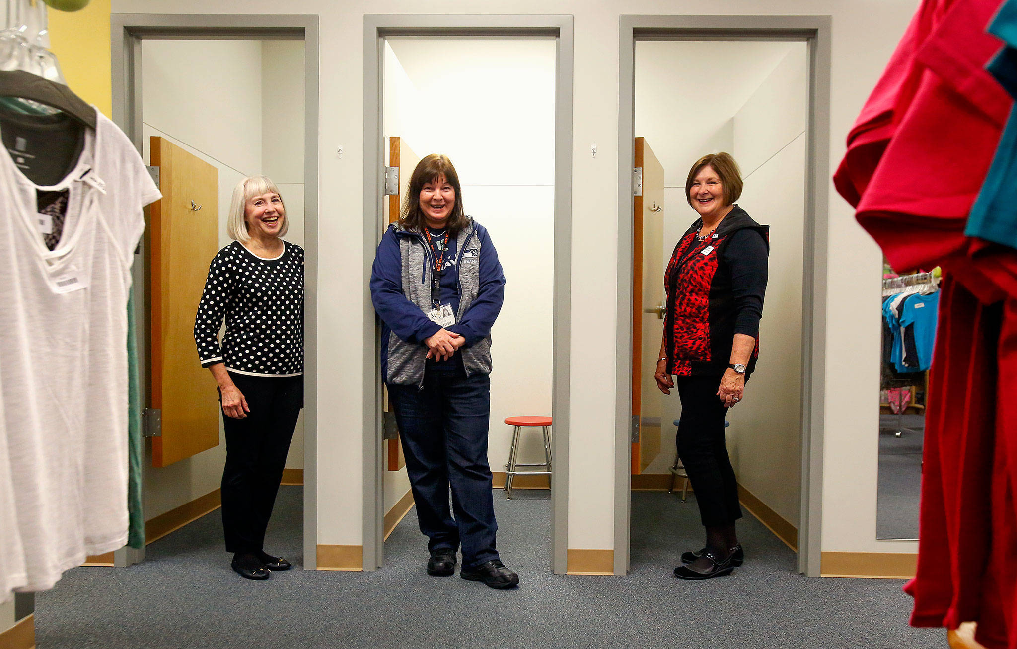 Three Assistance League of Everett volunteers stand ready in fitting rooms that help Operation School Bell assist kids in getting the clothes they want and need. They are Assistance League president Carla Hogan (left), Donna Day and Nancy Juntwait. The Assistance League of Everett is an all-volunteer organization that serves low-income families through Operation School Bell and other programs.