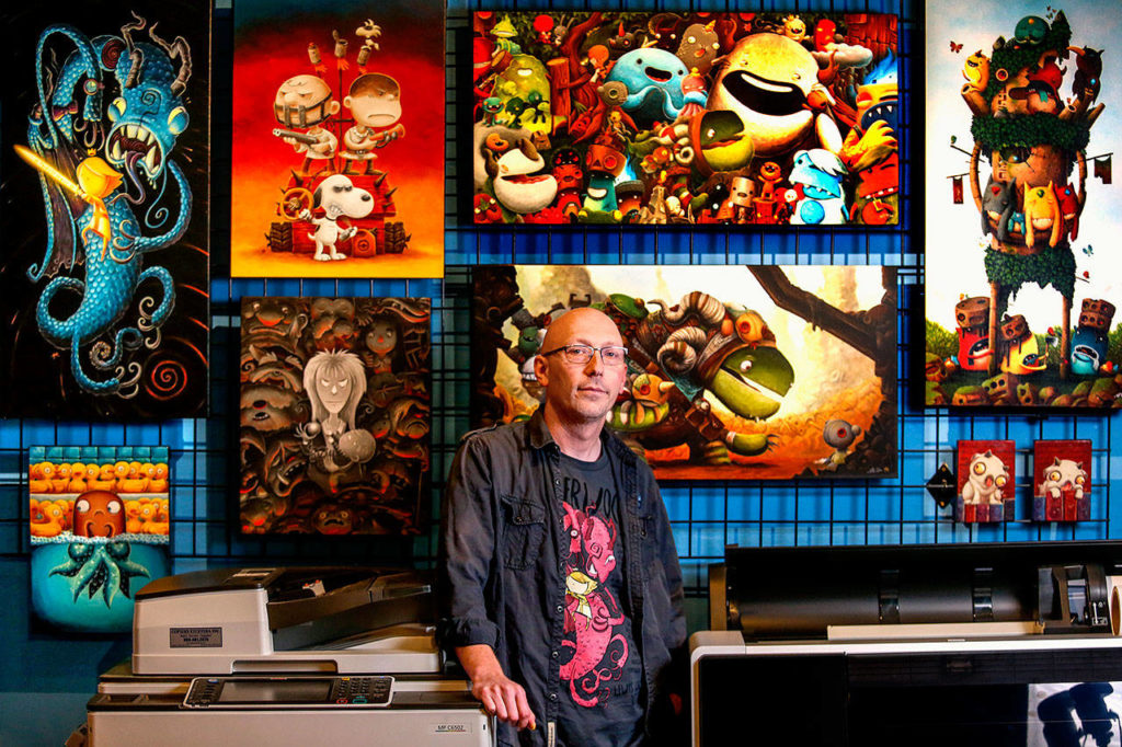 Artist Justin Hillgrove, creator of Imps and Monsters, in his studio. (Dan Bates / The Herald)
