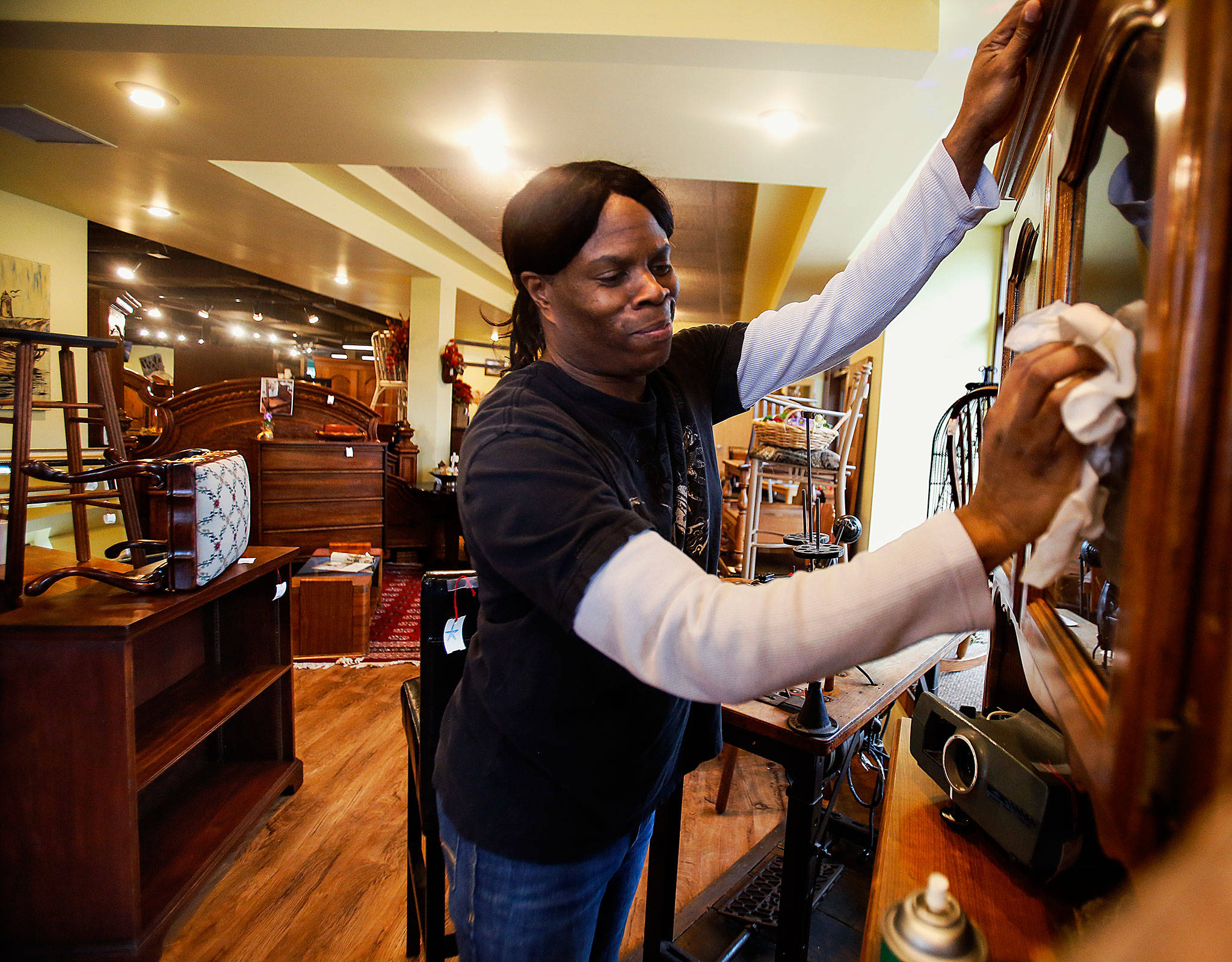 Nina White, 48, on the job caring for furniture at ReNewWorks Home and Decor, a shop run by HopeWorks in Everett. White has an internship with HopeWorks Social Enterprises, an organization that helps people gain job skills. (Dan Bates / The Herald)