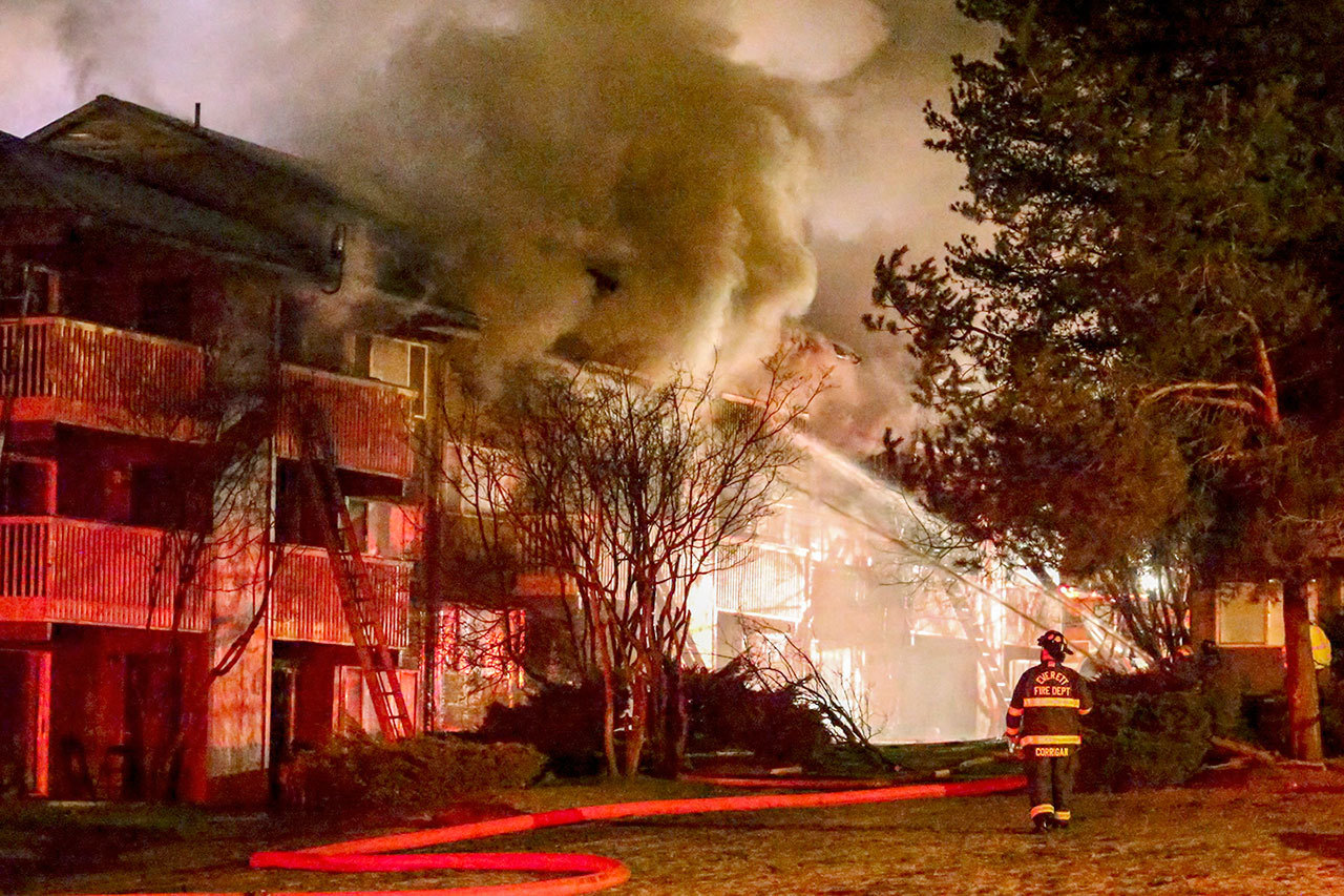 Firefighters battle an apartment fire at the Bluffs in Everett on Dec. 31, 2015. (Kevin Clark / Herald file)