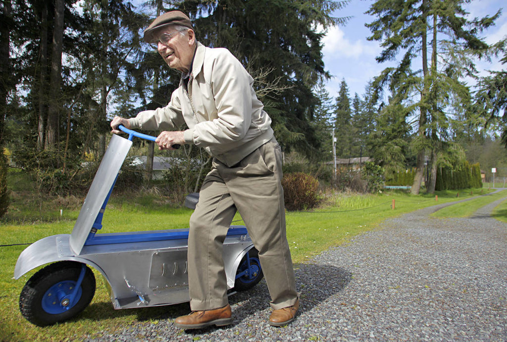 Mark Mulligan / Herald file
More than 60 years after first building a motorized scooter as a teenager in the late 1930s, Passow guides his newly designed and built scooter back into his garage after a ride in April 2011.
