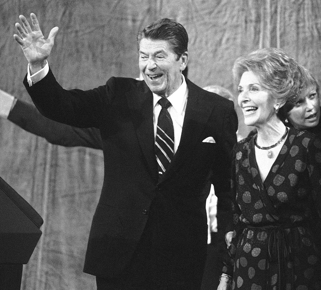 A triumphant Ronald Reagan and his wife, Nancy, greet supporters at his election night headquarters in Los Angeles on Nov. 5, 1980. Reagan defeated President Jimmy Carter in a landslide for the presidency. (Associated Press archive)