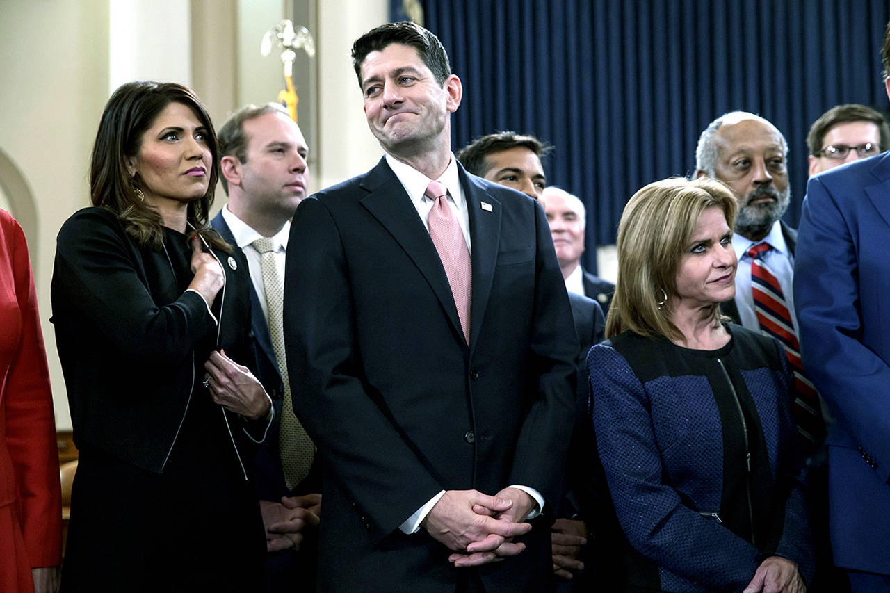 Speaker of the House Paul Ryan, R-Wis., flanked by Rep. Kristi Noem, R-S.D. (left) and Rep. Lynn Jenkins, R-Kansas, smiles as Republicans unveil their far-reaching tax overhaul, the first major revamp of the tax system in three decades, on Capitol Hill in Washington on Thursday. (AP Photo/J. Scott Applewhite)