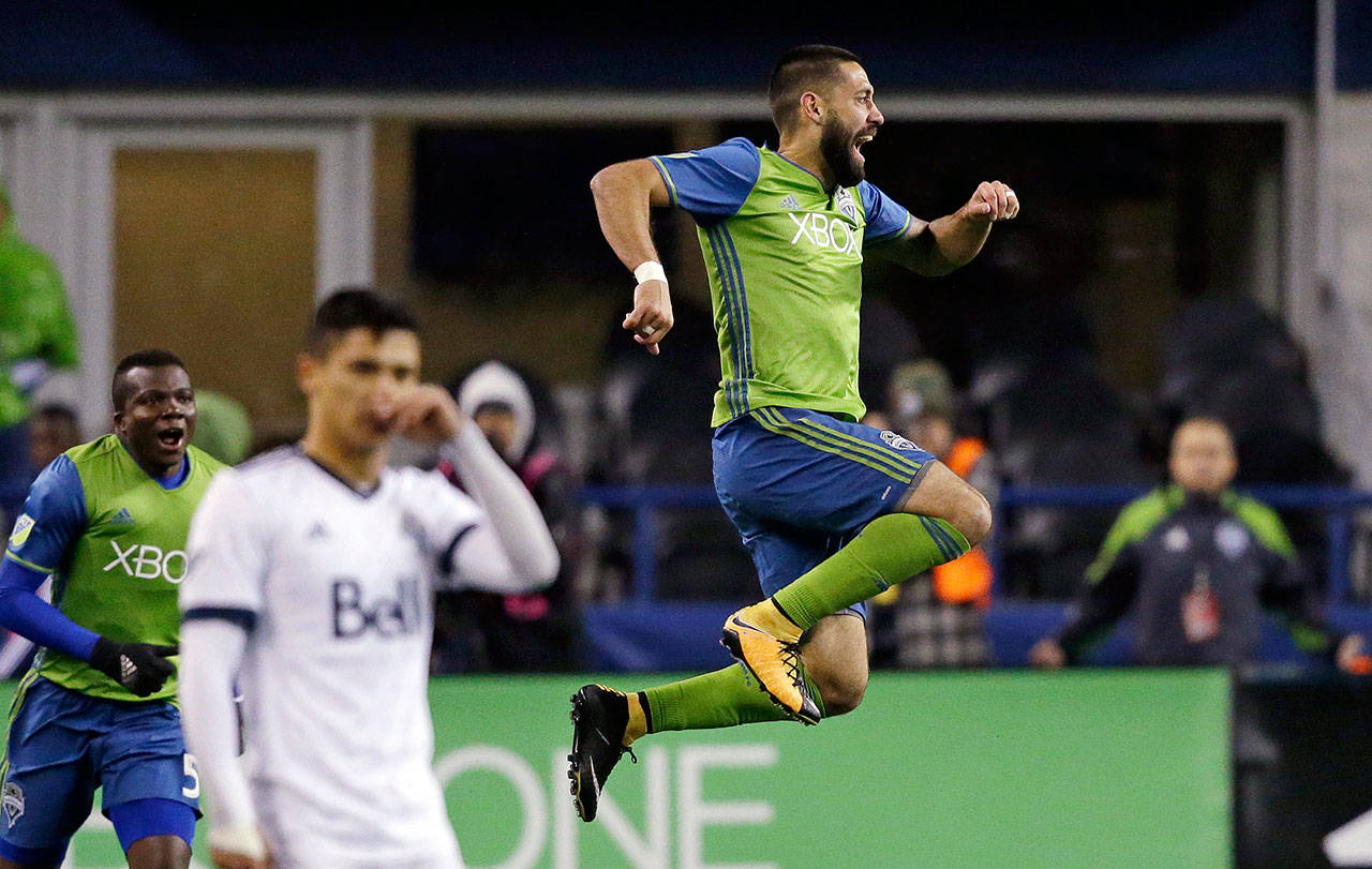 The Sounders’ Clint Dempsey leaps after scoring the first of his two goals against the Whitecaps during the second leg of an MLS Western Conference semifinal match on Nov. 2, 2017, in Seattle. The Sounders won 2-0. (AP Photo/Elaine Thompson)