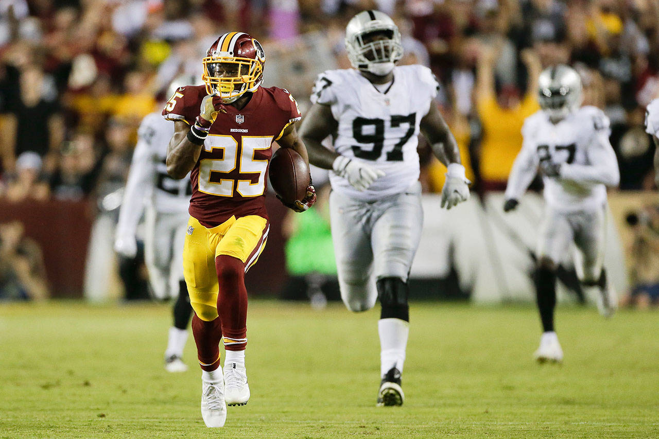 Redskins running back Chris Thompson (25) carries the ball during the second half of a game against the Raiders on Sept. 24, 2017, in Landover, Md. (AP Photo/Mark Tenally)