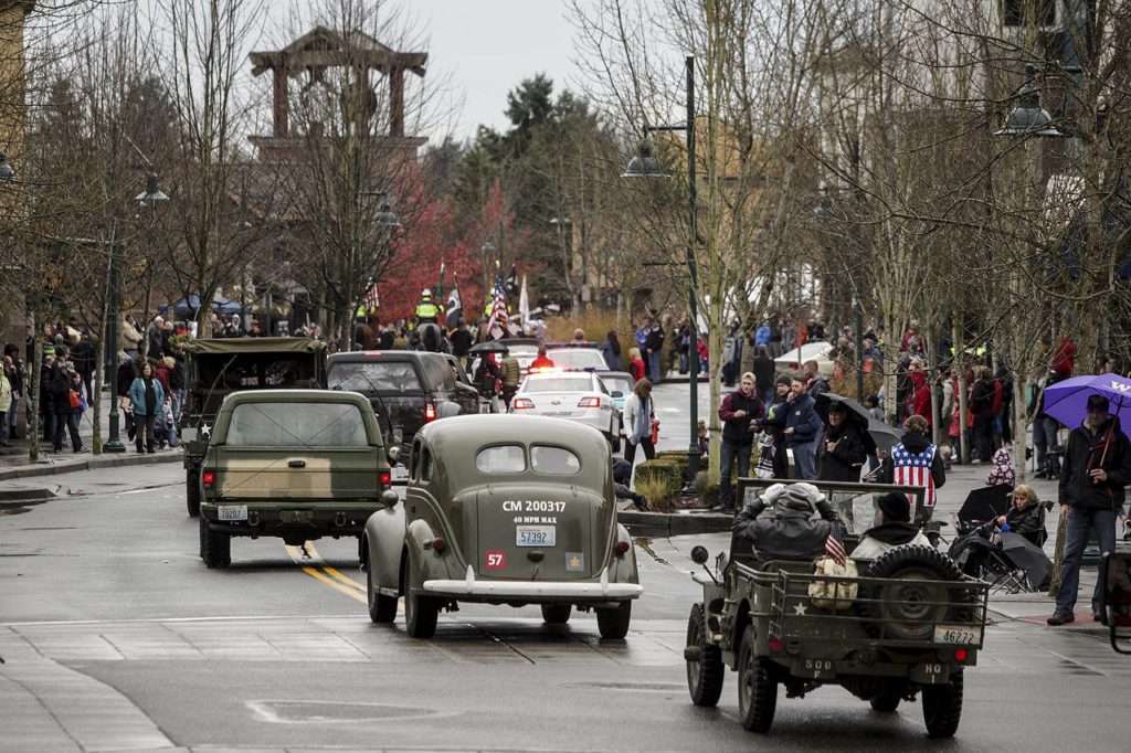 Participants in the Mill Creek Veterans Day parade make their way down Main Street in Mill Creek on Saturday. (Ian Terry / The Herald)
