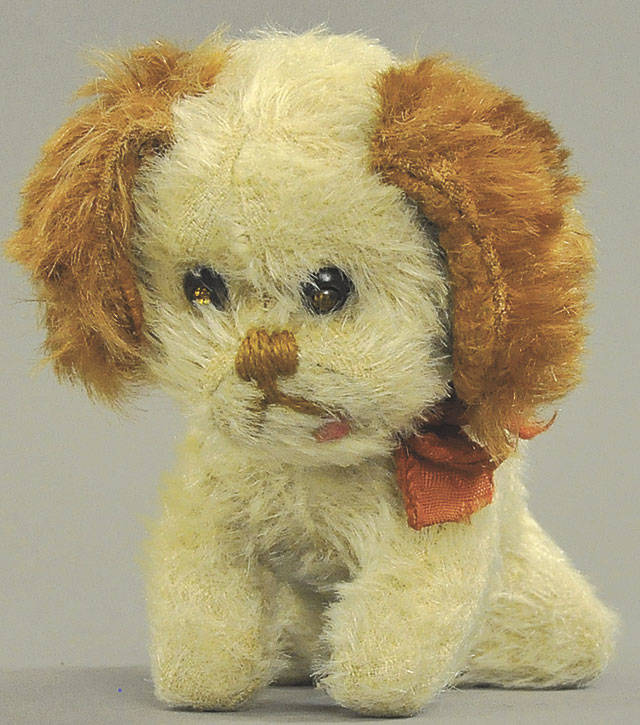 This 1930s Schuco toy spaniel with brown ears, a white body and a stitched nose and mouth sold for $900, which was three times the estimate. (Cowles Syndicate Inc.)