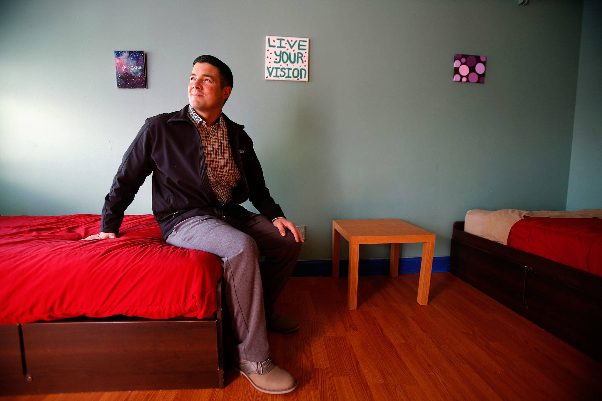 Joe Alonzo takes a look at a newly painted unit at Cocoon House on Pine Street in Everett. He is the new interim CEO of the teen shelter agency. (Dan Bates / The Herald)