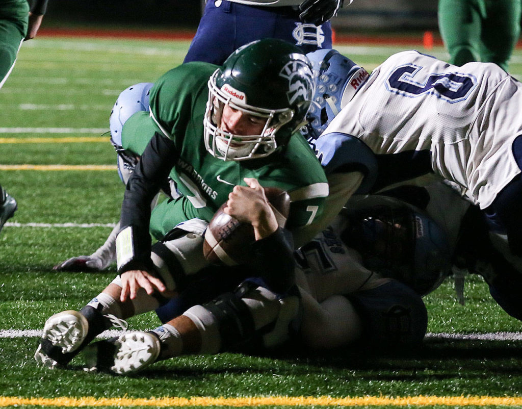 Edmonds-Woodway’s Reilly Chappell rolls over Gig Harbor’s Brenden Rivera for a touchdown during a Week 10 playoff game on Nov. 3, 2017, at Edmonds Stadium. (Kevin Clark / The Herald)

