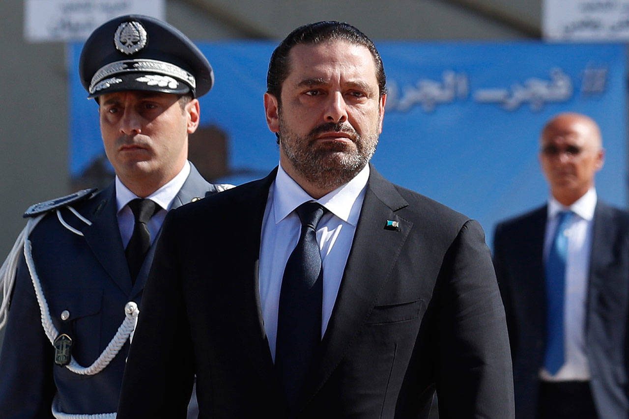 Lebanese Prime Minister Saad Hariri, left, arrives Sept. 8 for a mass funeral of ten Lebanese soldiers at the Lebanese Defense Ministry, in Yarzeh near Beirut, Lebanon. Lebanese prime minister Saad Hariri has announced he is resigning in a surprise move following a trip to Saudi Arabia. In a televised address Saturday, Nov. 4, he slammed Iran and the Lebanese Hezbollah group for meddling in Arab affairs and says “Iran’s arms in the region will be cut off.” (AP Photo/Hassan Ammar)