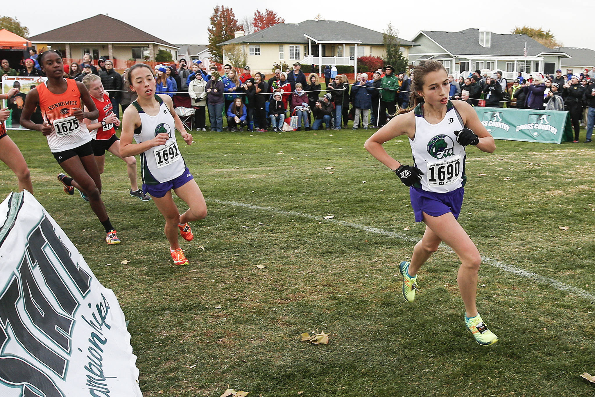 Edmonds-Woodway’s Olivia Meader Yetter (1690) leads the girls 3A pack with teammate Yukino Parle (1691) close behind during the state cross country championships on Nov. 4, 2017, at Sun Willows Golf Course in Pasco. (Ian Terry / The Herald)