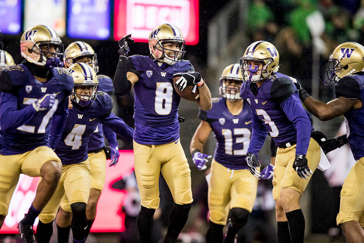 Washington’s Dante Pettis celebrates with teammates after his 64-yard punt-return touchdown against Oregon in the first half of a game Nov. 4, 2017, in Seattle. (Bettina Hansen/The Seattle Times via AP)
