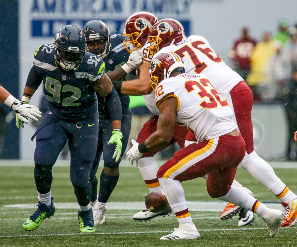 Redskins Samaje Perine fumbles with Seahawks defensive lineman Nazair Jones closing and recovering the ball Sunday afternoon at CenturyLink Field in Seattle on November 5, 2017. Redskins won 17-14. (Kevin Clark / The Herald)
