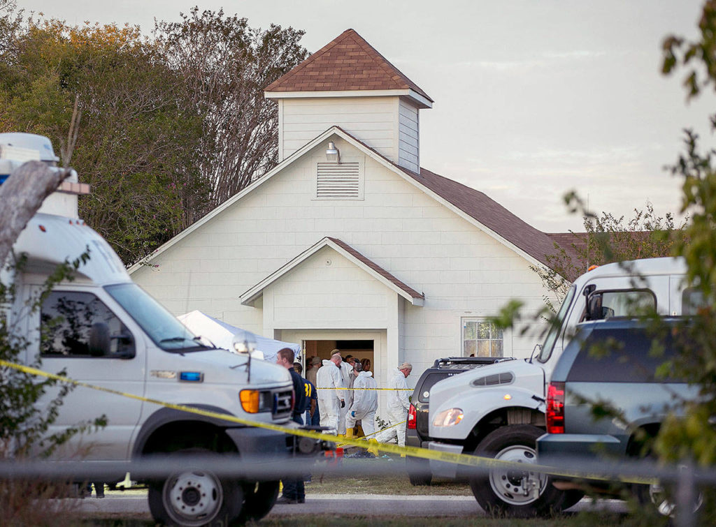 Investigators work at the scene of a deadly shooting at the First Baptist Church in Sutherland Springs, Texas, on Sunday. (Jay Janner/Austin American-Statesman via AP)
