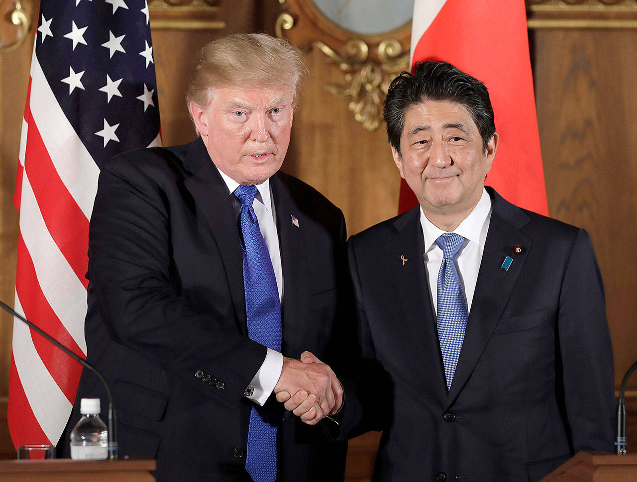 President Donald Trump (left) shakes hands with Japanese Prime Minister Shinzo Abe during a joint news conference at the Akasaka Palace on Monday in Tokyo. Trump is on a five country trip through Asia, traveling to Japan, South Korea, China, Vietnam and the Philippines. (Kiyoshi Ota/Pool Photo via AP)