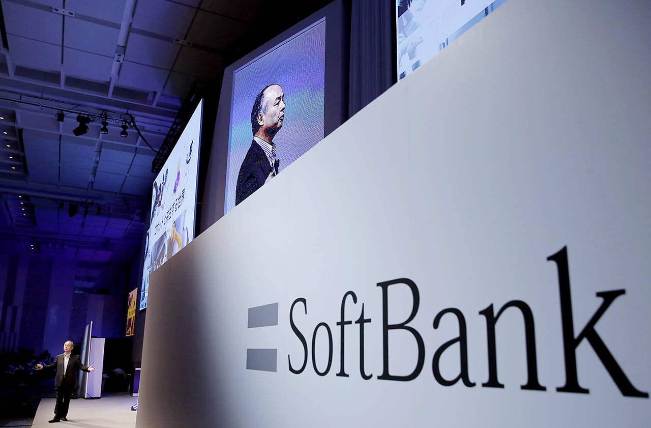 In this July 20 photo, SoftBank Group Corp. Chief Executive Officer Masayoshi Son (left) speaks during a SoftBank World presentation at a hotel in Tokyo. (AP Photo/Shizuo Kambayashi, File)
