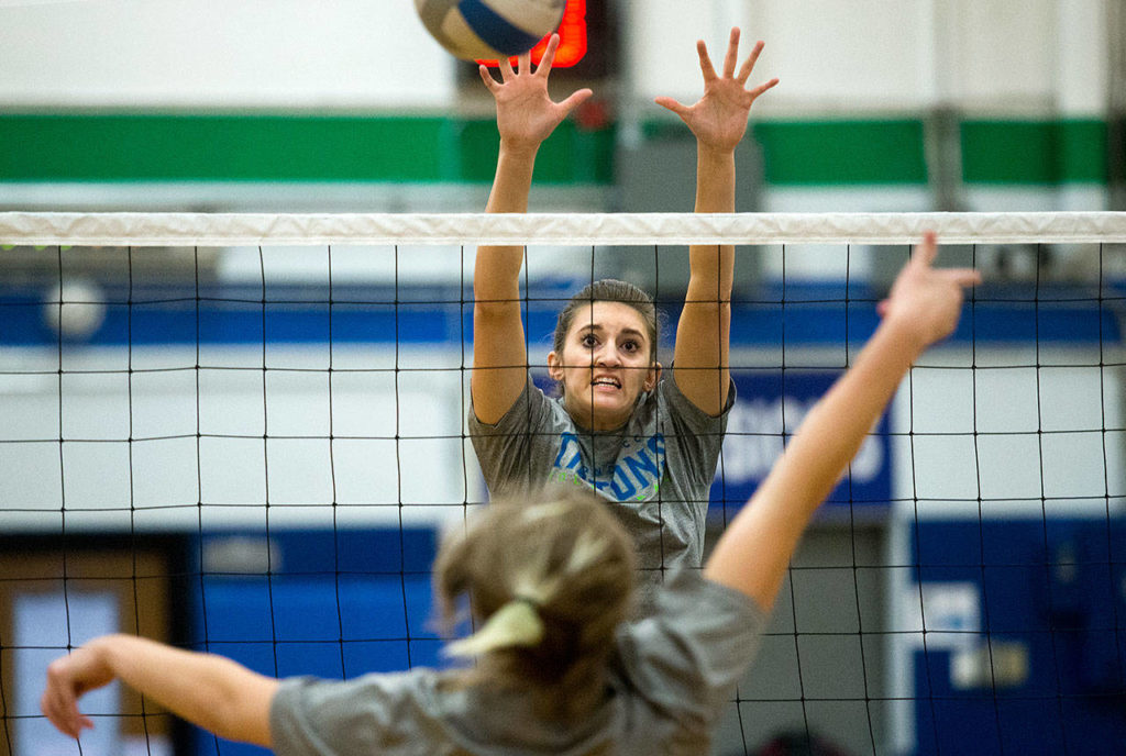 Edmonds Community College’s Sydney Lawrence goes up for a block during the Tritons’ practice on Monday in Edmonds. (Andy Bronson / The Herald)
