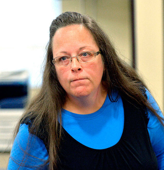 In this 2015 photo, Rowan County Clerk Kim Davis listens to a customer at the Rowan County Courthouse in Morehead, Kentucky. (AP Photo/Timothy D. Easley, File)