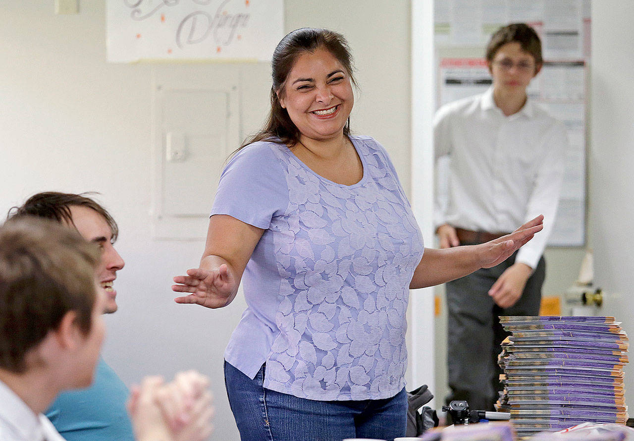 Manka Dhingra, candidate for the 45th District state Senate seat, talks with volunteers at her campaign headquarters in Redmond. (AP Photo/Elaine Thompson, File)