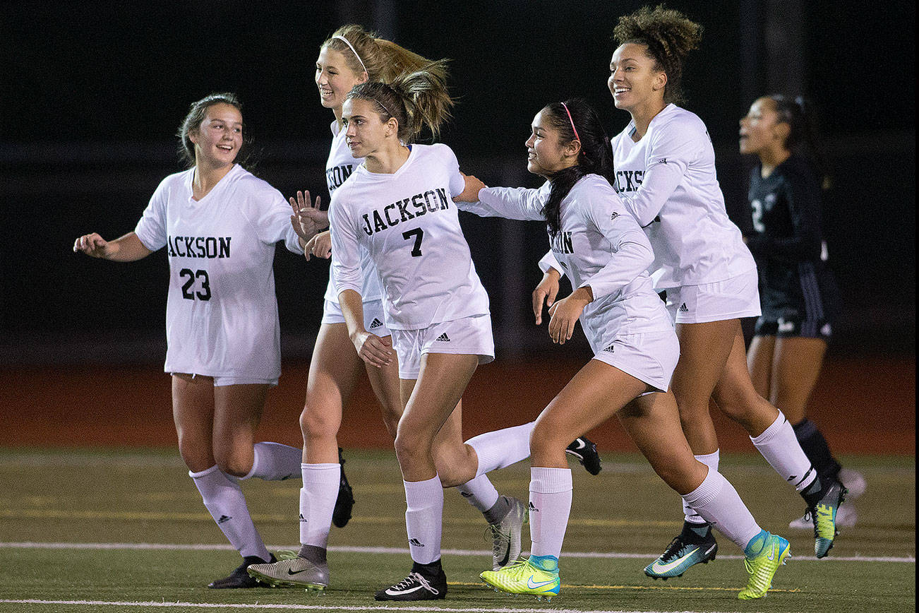 Jackson High’s Keile Hansen (7) is congratulated by teammates after scoring a goal in the first half as the Timberwolves took on Union High School in a girls’ soccer match at Everett Memorial Stadium on Tuesday, Nov. 7, 2017 in Everett, Wa. (Andy Bronson / The Herald)