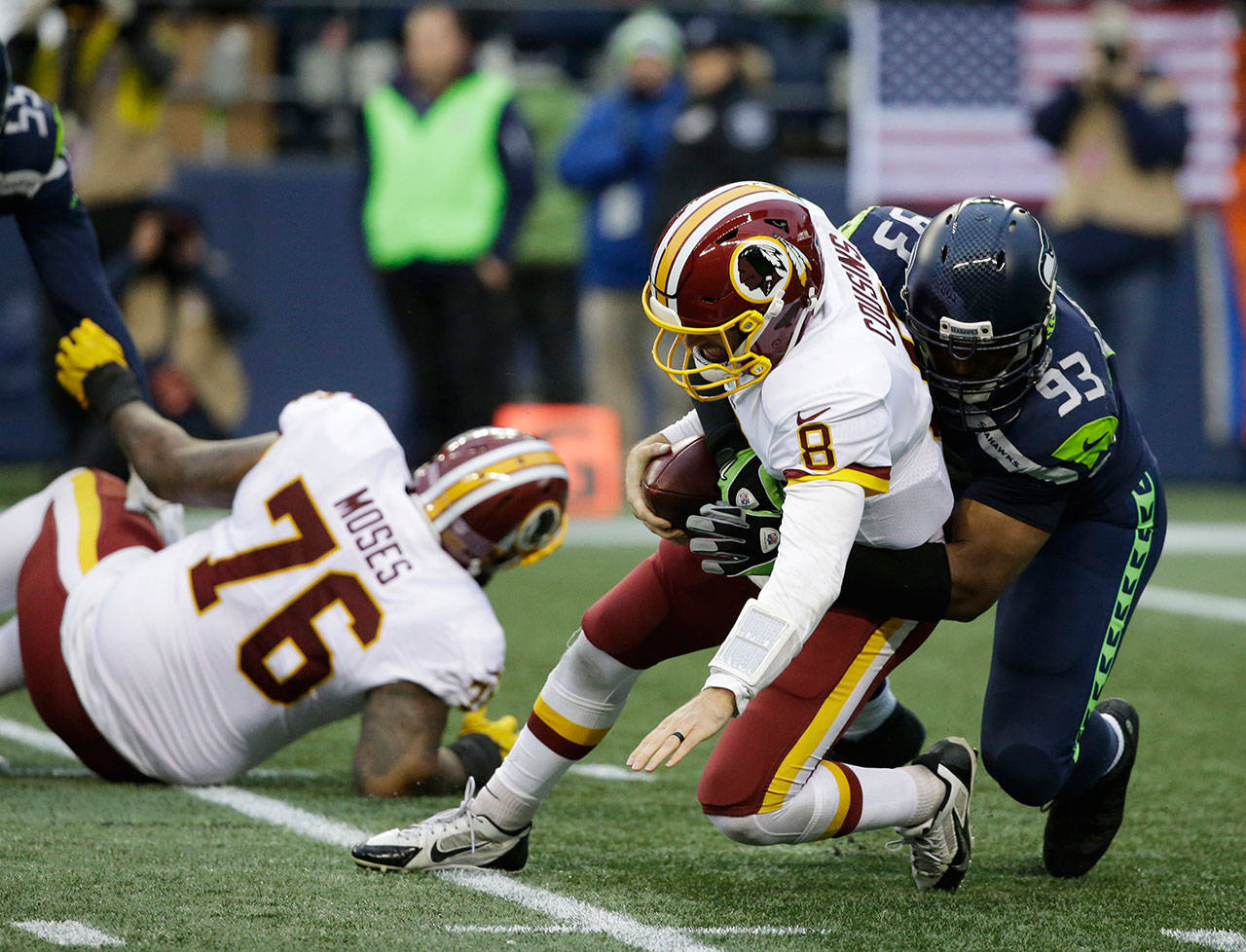 Seahawks defensive end Dwight Freeney (93) sacks Redskins quarterback Kirk Cousins (8) in the second half of a game Nov. 5, 2017, in Seattle. (AP Photo/Elaine Thompson)