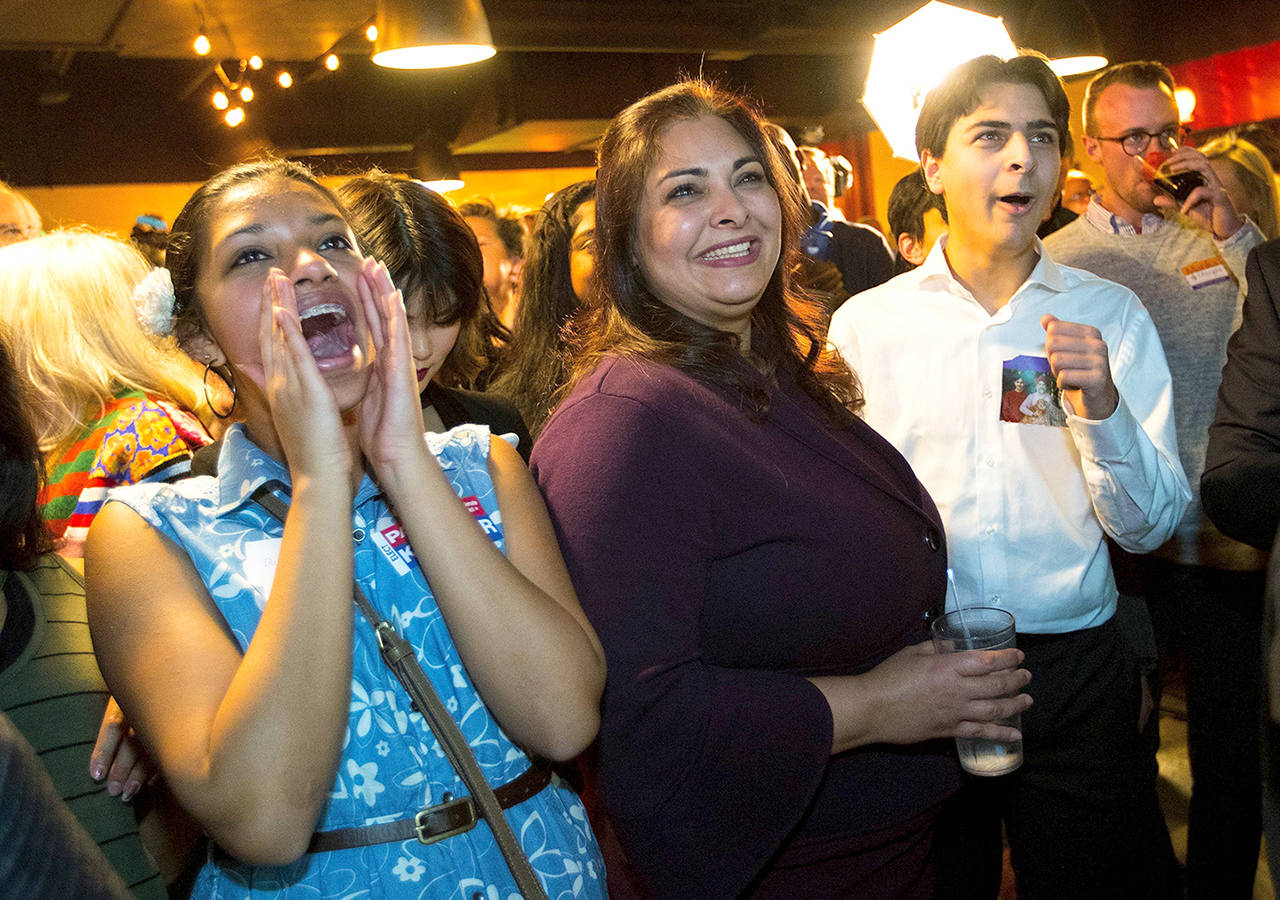State Senate candidate Manka Dhingra (center) is congratulated by supporters Tuesday night in Woodinville. (Mike Siegel/The Seattle Times via AP)